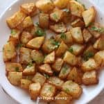 air fryer diced potatoes on a white plate